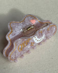 A 10cm celestial-themed acetate hair clip in pink with a moon motif with rhinestone accent