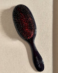 Black hair brush with mixed boar and nylon bristles for detangling and shine - Slik & Sleek London luxury collection