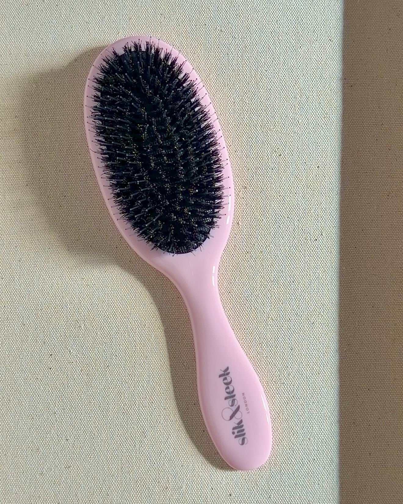 Pink hairbrush with mixed boar and nylon bristles gentle brushing of hair extensions  - Slik &amp; Sleek London hair health specialist